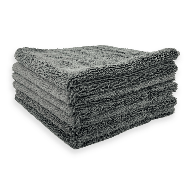 Stack of grey microfibre cloths on a white background