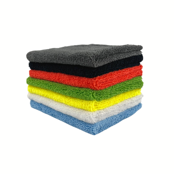 A stack of microfibre cleaning cloths in various colours including blue, red, green, yellow, black, and white.