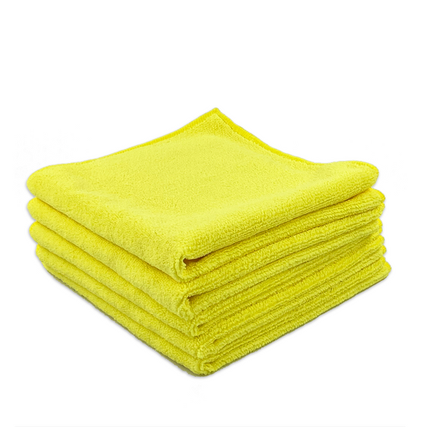 A stack of four microfibre cloths in yellow, neatly folded and arranged on top of each other
