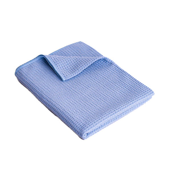 A large blue waffle woven microfibre cloth on a white background