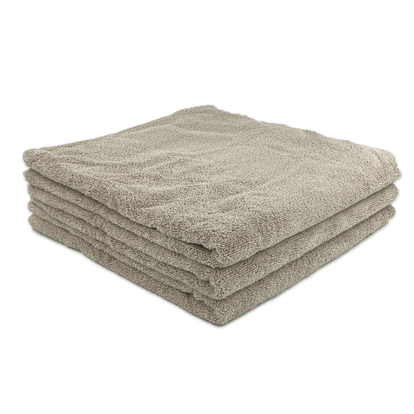 A stack of beige microfibre bath towels