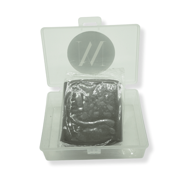 Clear plastic container with heavy grade clay bar inside on a white background