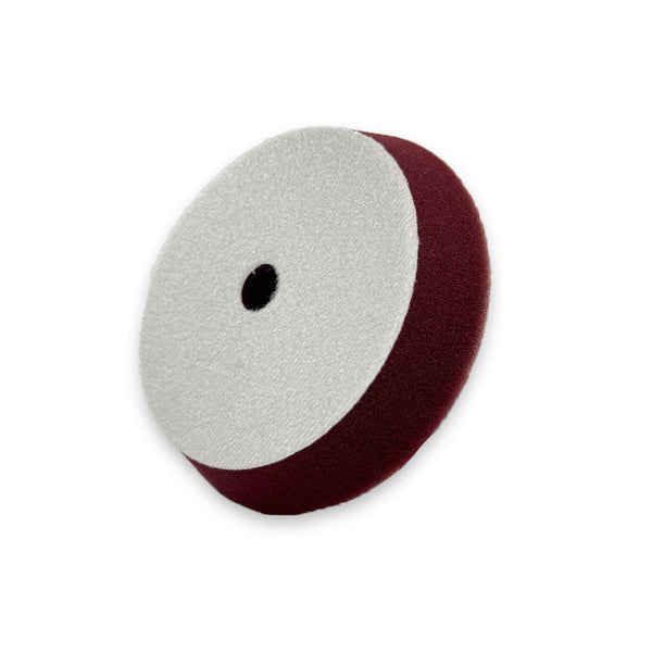 A maroon beveled edge buffing pad made from US foam, designed for dual action buffing and suitable for use with a velcro backing plate.