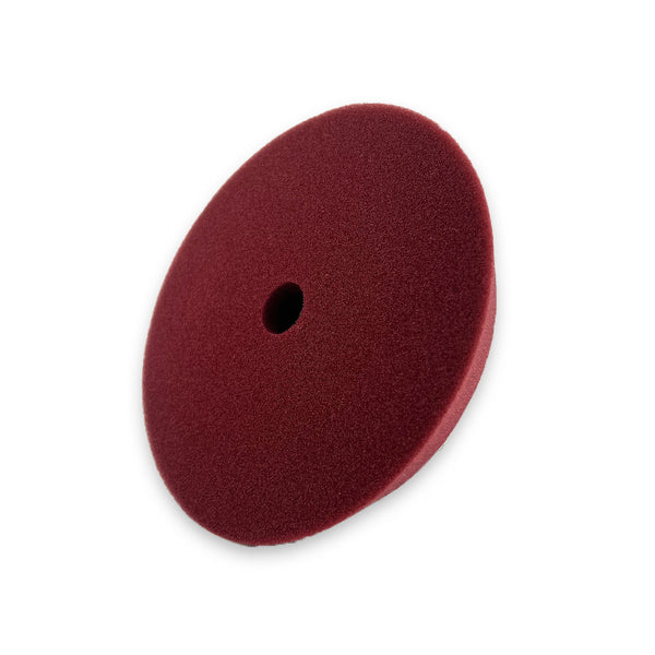 A red beveled edge buffing pad made from US foam, designed for dual action buffing and suitable for use with a velcro backing plate.
