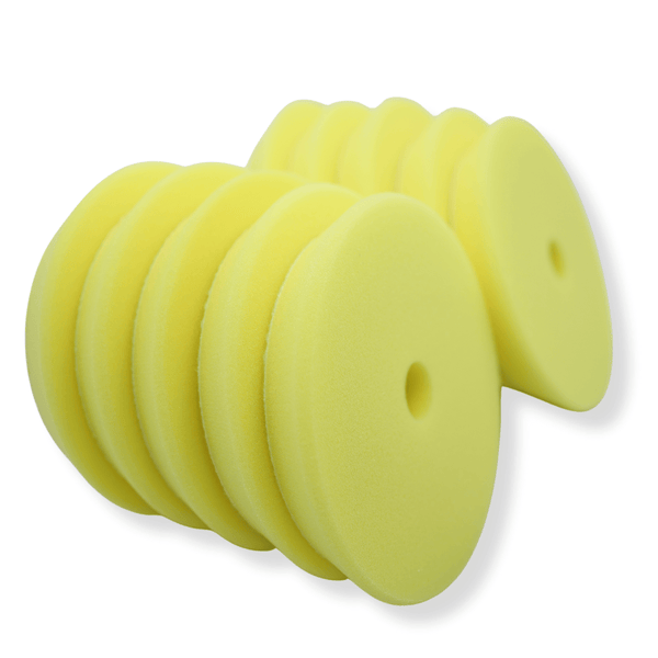 A stack of yellow 5inch buffing pads on a white background