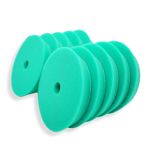 A stack of green 6 inch foam buffing pads on a white background