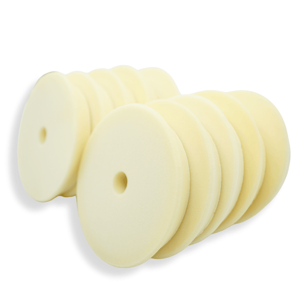 A stack of white 6 inch foam buffing pads on a white background
