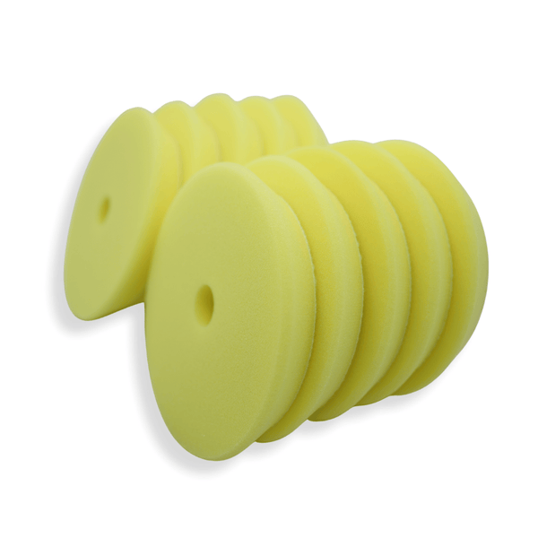 A stack of yellow 6 inch foam buffing pads on a white background