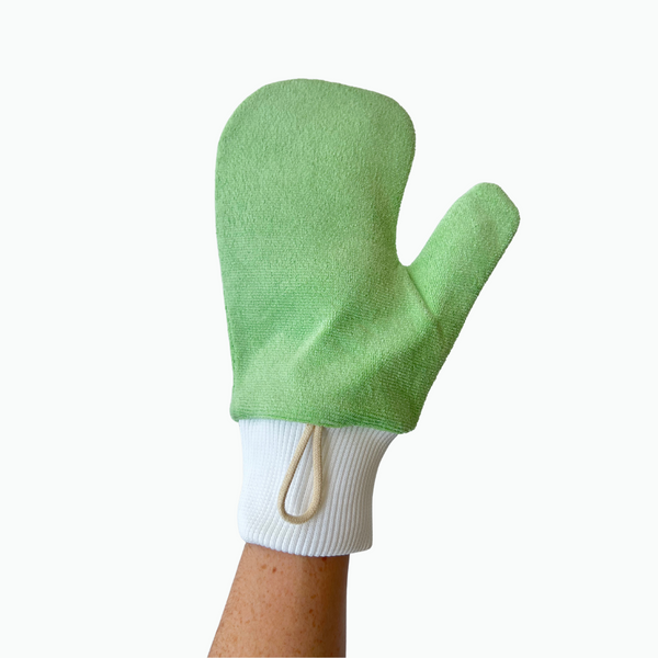 A green microfibre cleaning mitt worn on a person's hand, with a white cuff and a wrist loop.
