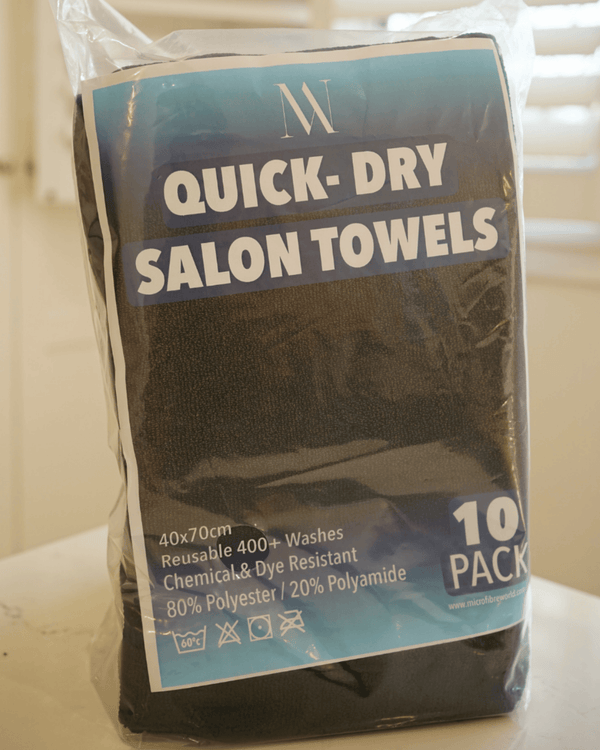 Pack of quick-dry salon towels with branding on a neutral background