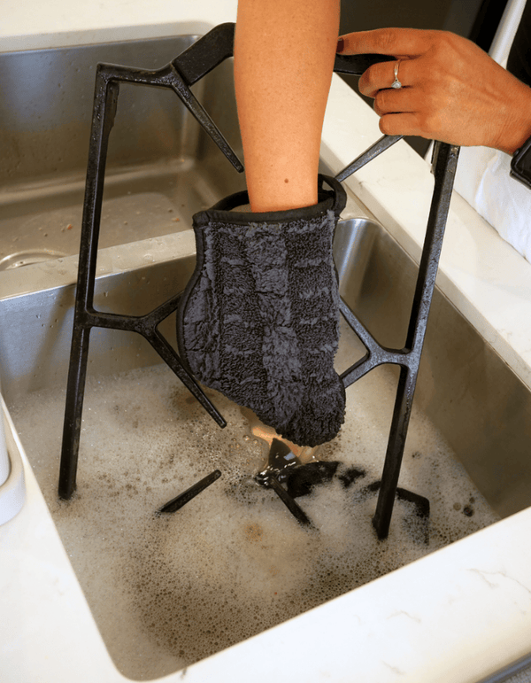 A person cleaning with a microfibre kitchen cleaning glove