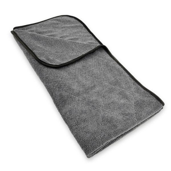 Folded grey microfiber towel on a white background