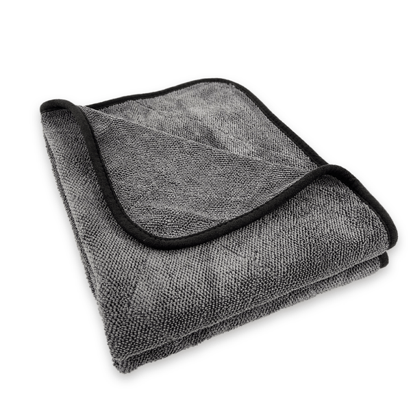 Folded grey microfiber cloth with black border on a white background