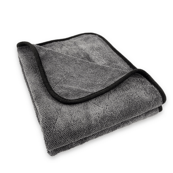 Folded grey microfibre drying towel in a white background