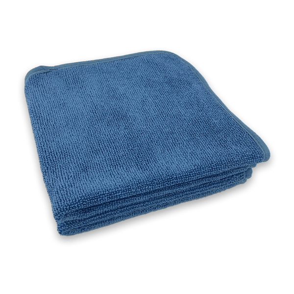 A blue microfibre towel with a dark blue edge on a white background