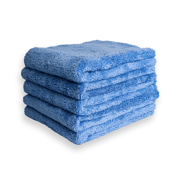 A stack of plush blue microfibre cloths on a white background