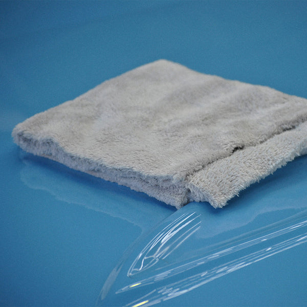 A plush white microfibre cloth on a car bonnet