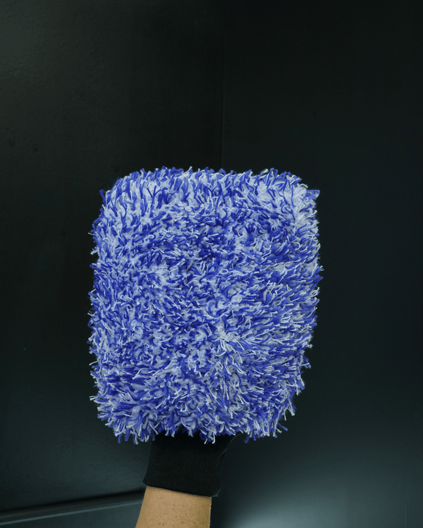 A person wearing a blue and white microfibre car wash mitt