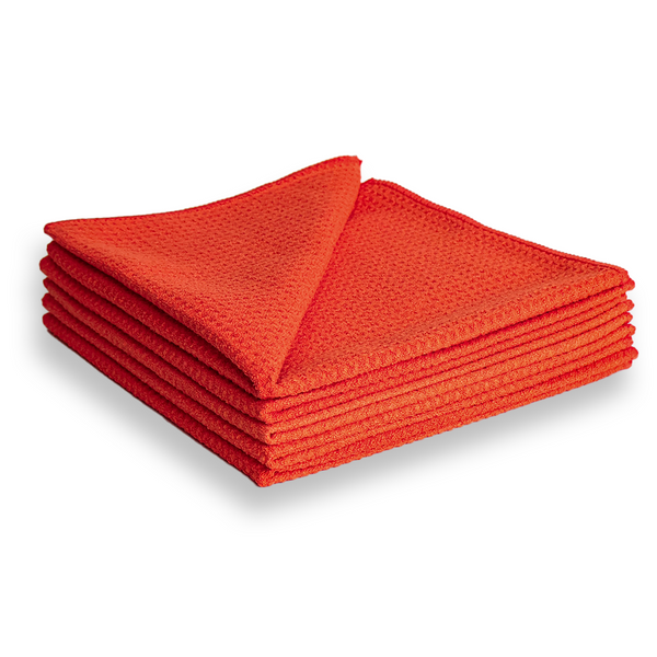 A stack of red waffle weave microfibre cloths.