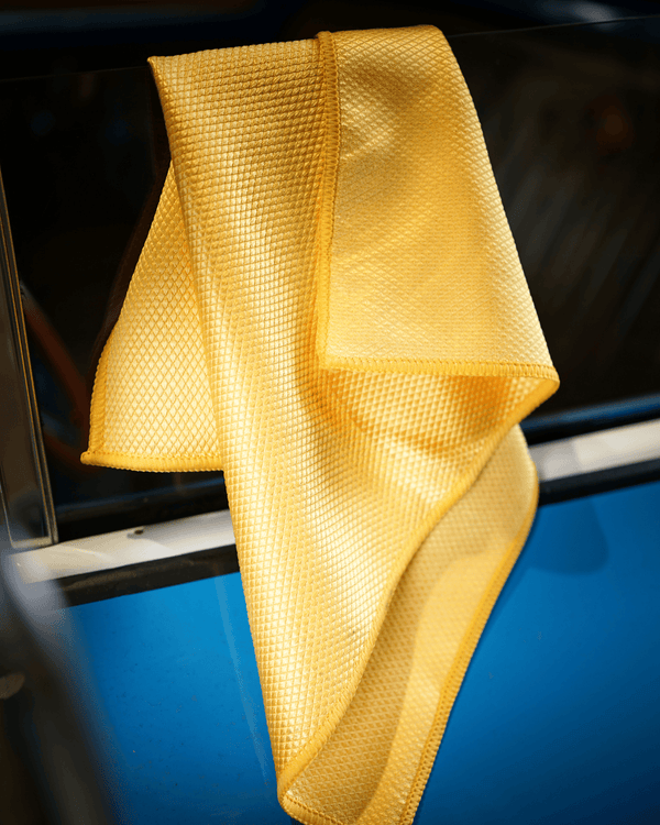 Yellow microfiber cloth on a car window