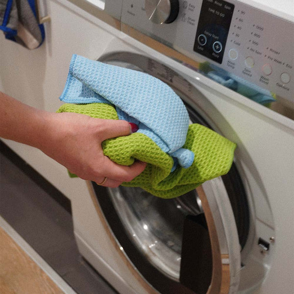 A blue and green waffle weave cloth put into washing machine