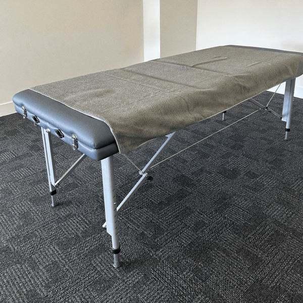 A massage towel layed across a massage bed
