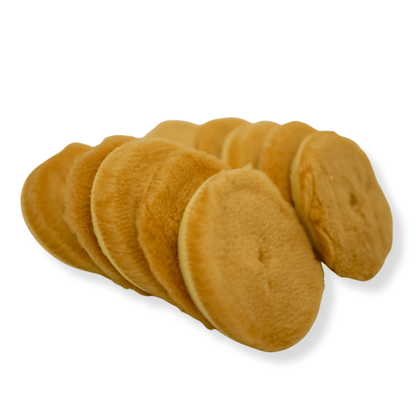 A stack of orange 3inch wool buffings pads