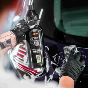 Gloved Hands Applying ADBL Wash and Clay Shampoo from 1L Bottle during Car Decontamination and Washing Process