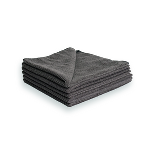 A stack of grey microfibre cleaning cloths on a white background