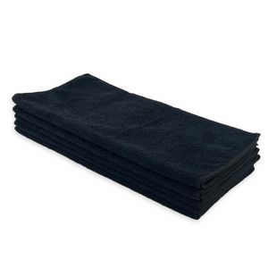 A stack of black microfibre cloths on a white background