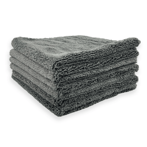Stack of grey microfibre cloths on a white background