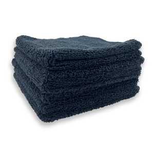 A stack of black microfibre cloths on a white background