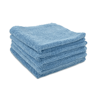 A stack of blue microfibre cloths neatly folded on a white background