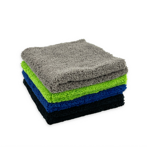 A stack of plush microfibre cloths in various colours of grey, green, blue and black on a white background