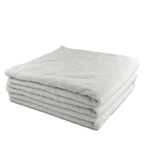 A stack of white microfibre bath towels
