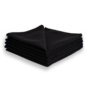 A stack of black waffle weave microfibre cloths.
