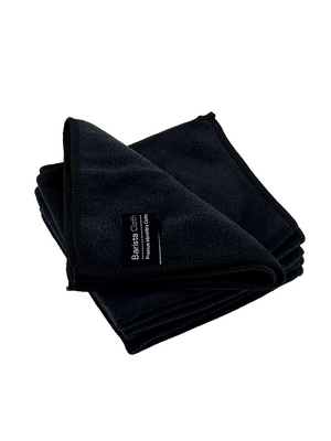 A stack of dark microfibre cleaning cloths with a label on the bottom one displaying the brand 'Barista Care'.