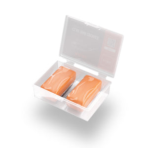 A box of orange soft clay bars on a black background