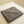 A charcoal folded microfibre cloth on a kitchen bench