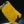 A person wearing black gloves holding a large yellow noodle sponge on a dark background 