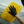 A person wearing black gloves using a large yellow noodle sponge to clean a white car