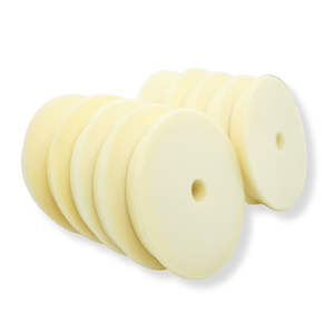 A stack of white 5inch buffing pads on a white background