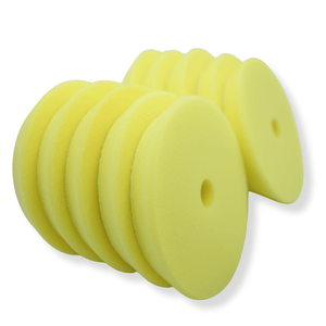 A stack of yellow 5inch buffing pads on a white background