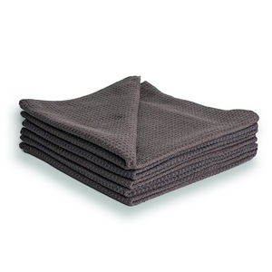 A stack of grey waffle weave microfibre cloths.