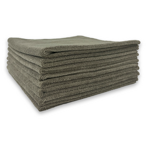 Stack of folded taupe towels on a white background