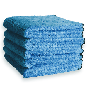 A stack of blue plush hybrid weave microfibre on a white background