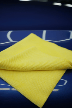 Yellow microfibre cloth on a blue surface