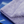 A folded purple microfibre cloth on a blue surface