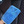A person holding a blue car interior scrub mitt cleaning a leather car seat
