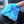 A person holding a blue interior scrub mitt cleaning a car dashboard